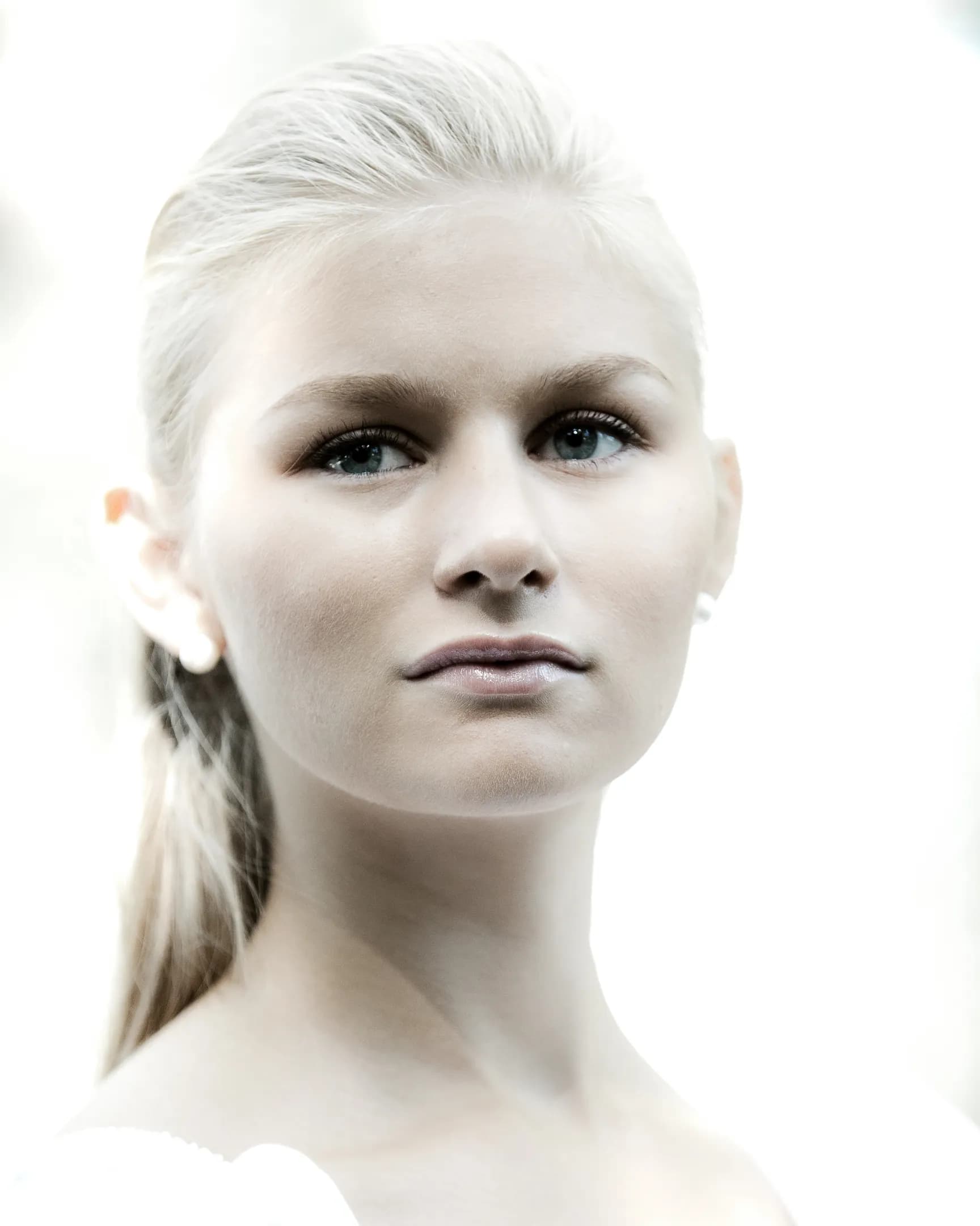 Emily with light blonde hair, looking directly at the camera with a neutral expression.
