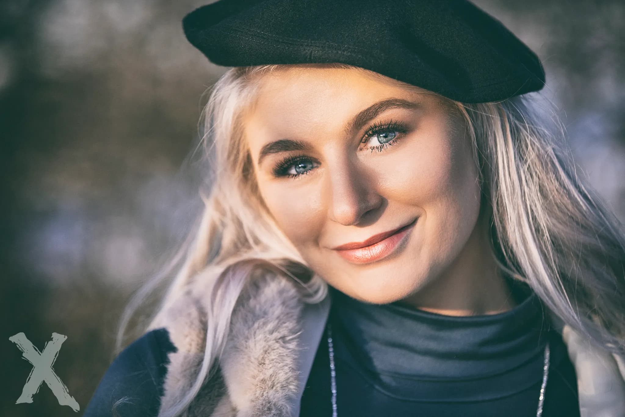 Emily wearing a black beret and a fur-trimmed coat, smiling outdoors.